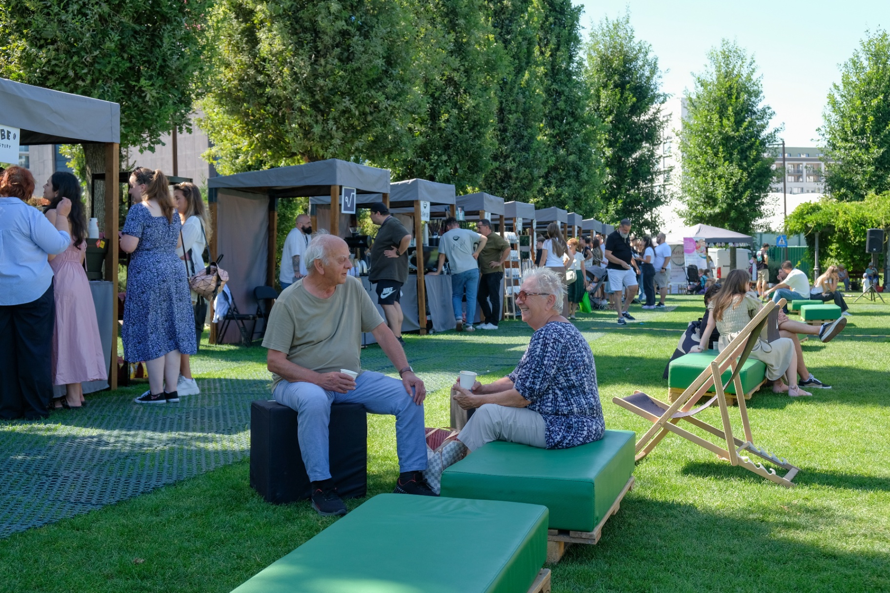 People relaxing on the grass and enjoying the festival atmosphere