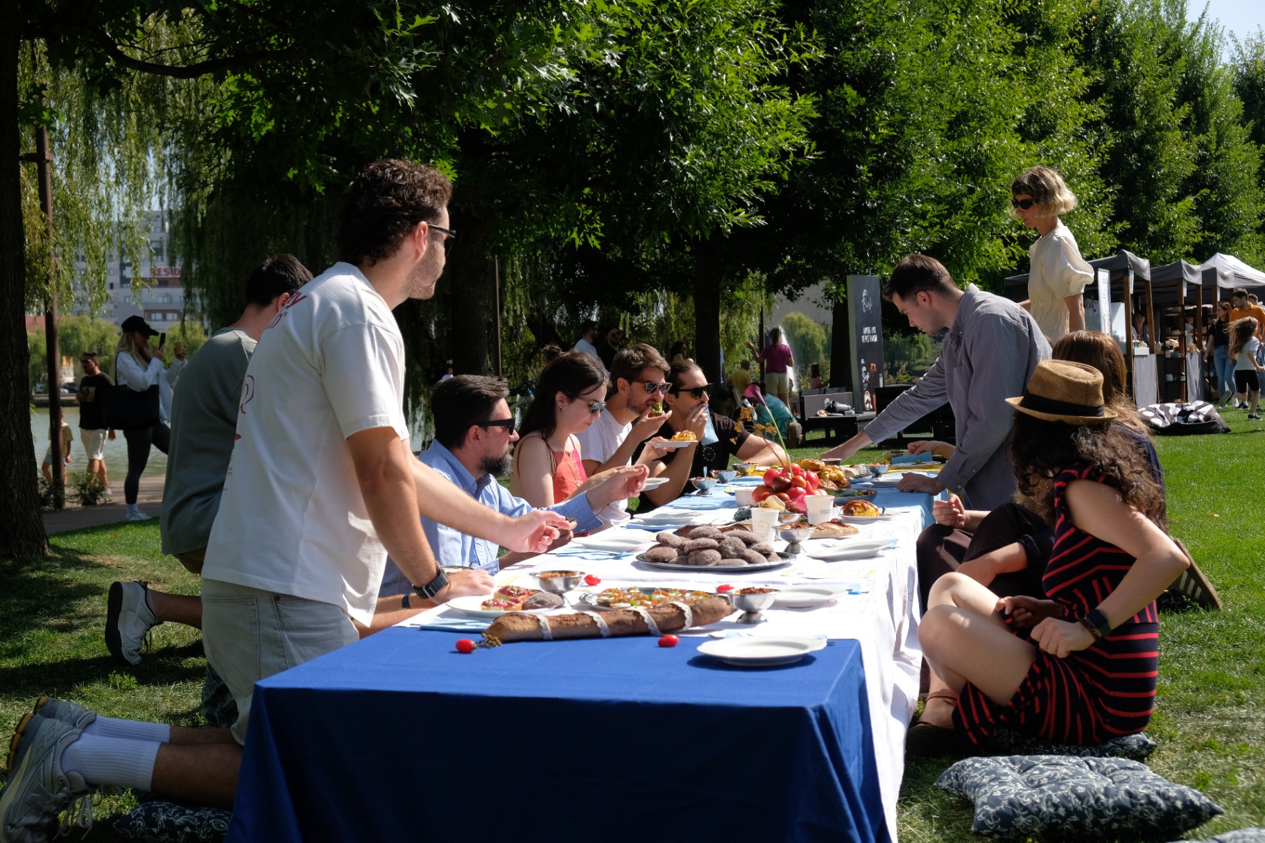 Outdoor summer brunch table set beside the lake